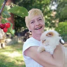 Bianka Hones mit einem weißen Kaninchen im Tierheim-Garten